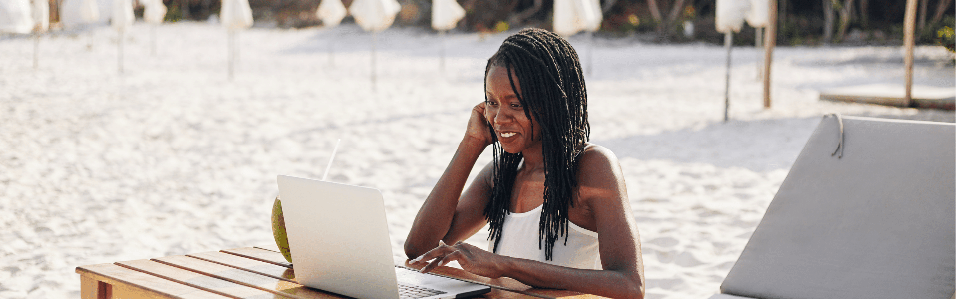 woman working from the beach thanks to cloud-based bookkeeping