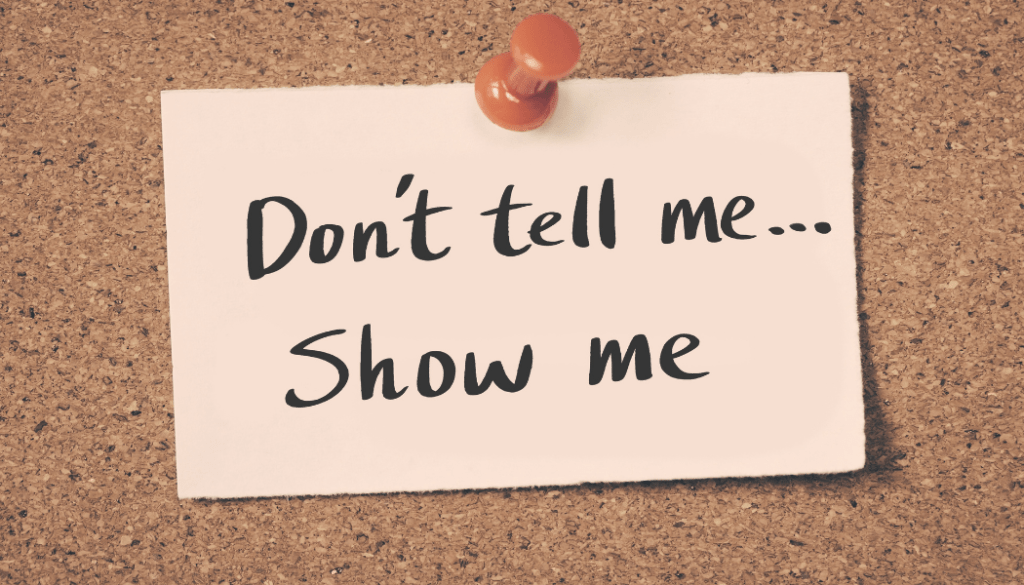 Note pinned to a cork board saying "Don't tell me...show me", a piece of interview advice